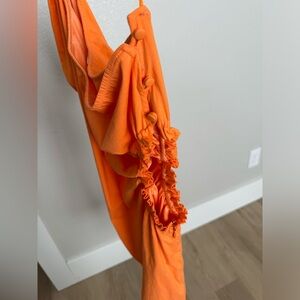 This formal mini dress is one shoulder with a cut out on the side.